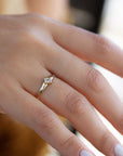 A delicate 14k yellow gold engagement ring set with a center 0.25 carat princess cut white diamond.