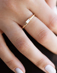 A delicate 14k yellow gold engagement ring, set with a 0.25 baguette cut white diamond.