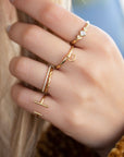 A dainty 14k yellow gold eternity ring, set with fifty 0.01 carat white diamonds all over.
