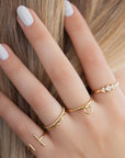 A dainty 14k yellow gold ring, with a hanging hoop.  