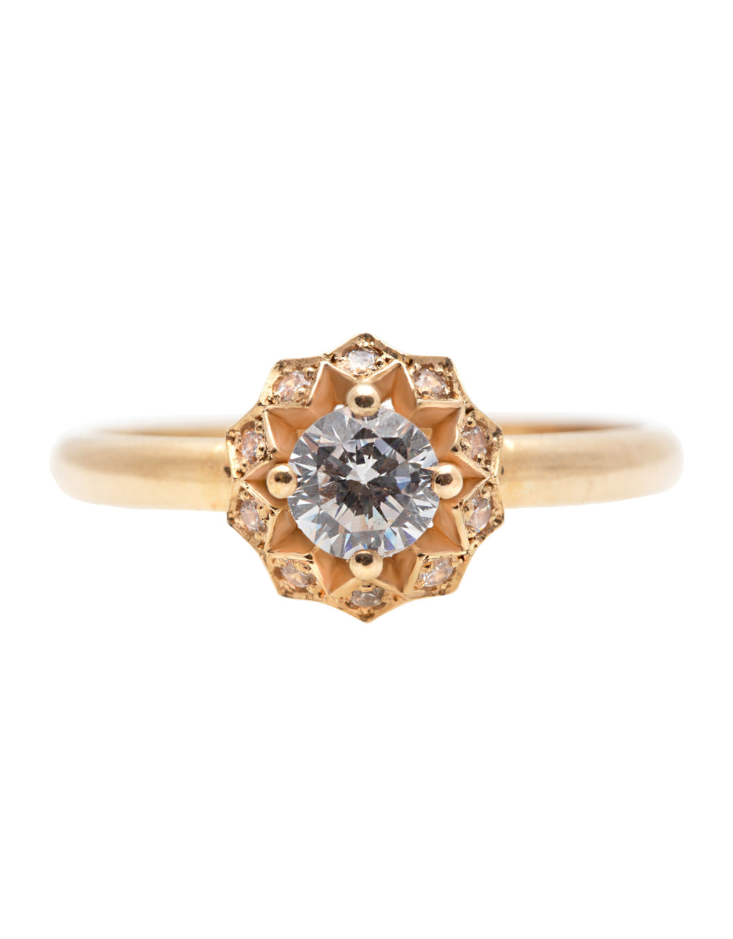 A delicate 14k yellow gold engagement ring, set with a center brilliant cut white diamond and smaller diamonds around it, in the shape of a geometric flower. 