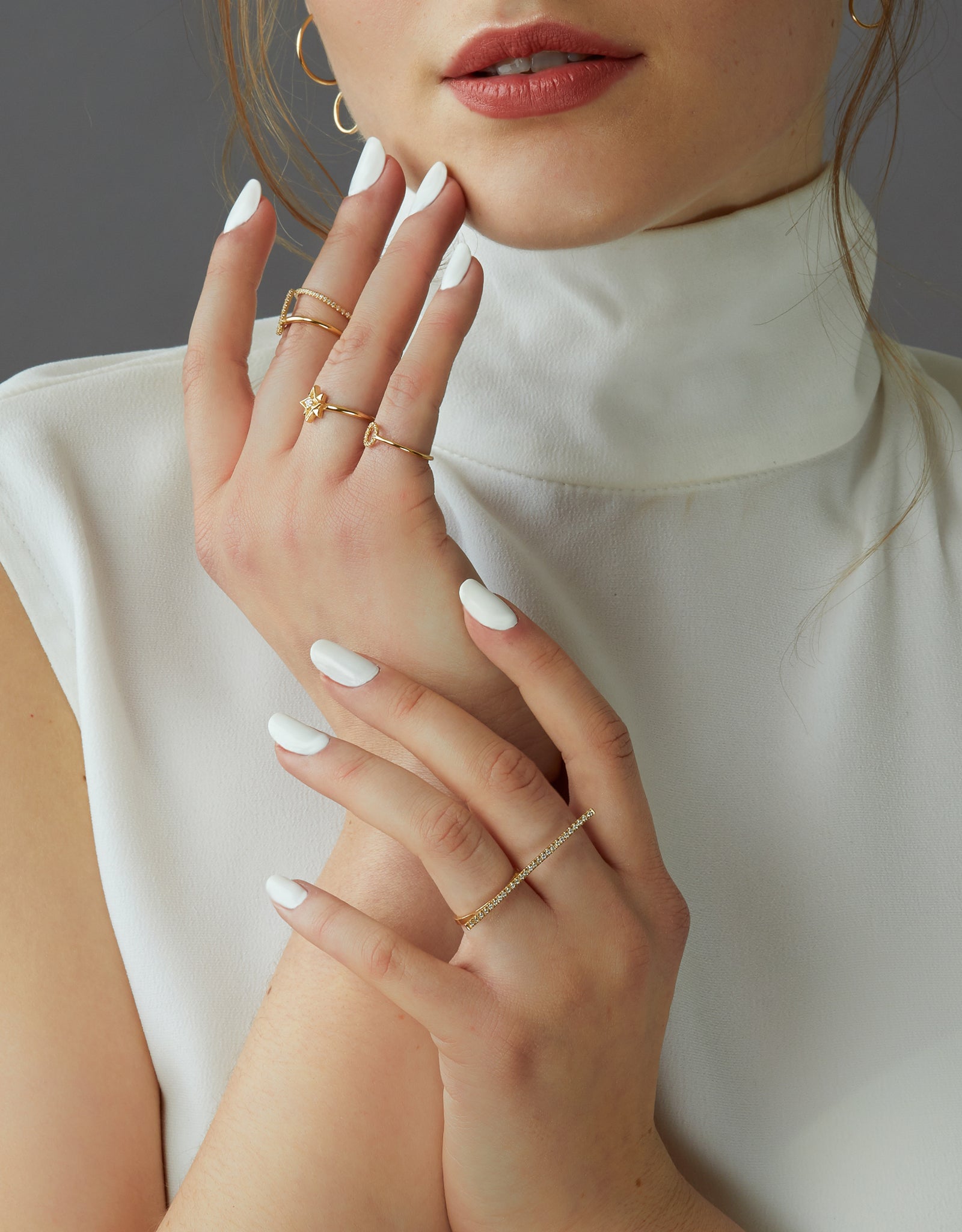 A dainty 14k yellow gold two finger ring, with a long bar set with white diamonds, that covers both fingers.