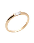 A  delicate 14k yellow gold engagement ring, set with a 0.25 baguette cut white diamond. 