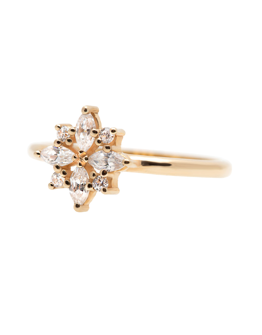 A delicate 14k yellow gold engagement ring set with four marquise cut white diamonds, and four brilliant cut white diamonds, in a shape of a snowflake.