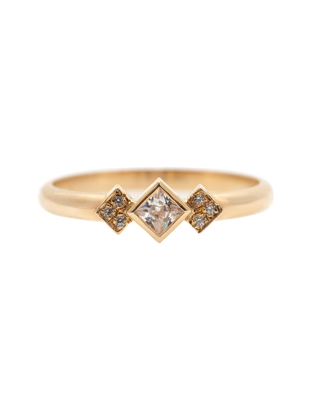 A delicate 14k yellow gold engagement ring, set with a center 0.25 carat princess cut white diamond, and three 0.01 carat brilliant cut white diamonds on each side.