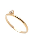 A dainty 14k yellow gold ring, set with one tiny, brilliant cut white diamond.